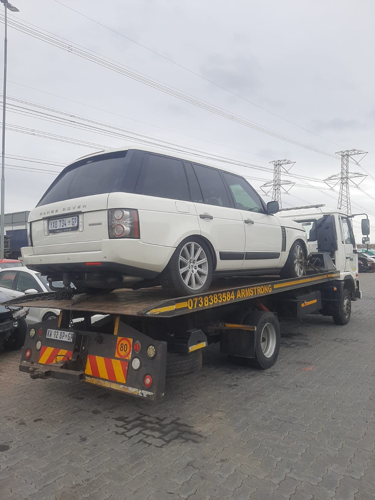 White Range Rover secured on an Armstrong Towing flatbed